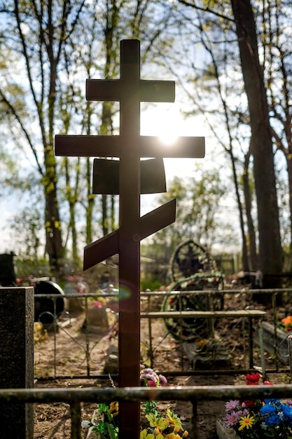 Grave cross on the Orthodox Christian cemetery at sunny day