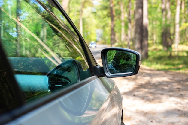 Gray car in the forest Farview mirror Side mirror of the car