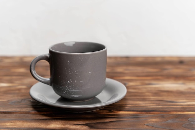 Gray Coffee Cup on Wooden Table