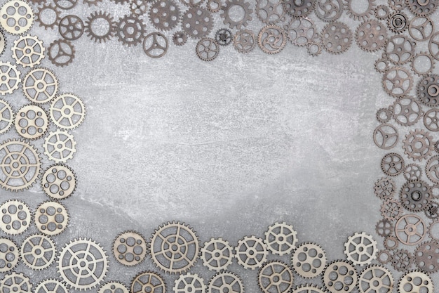 Gray concrete background with gears and copy space