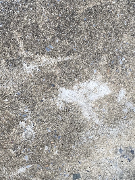 A gray concrete floor with white paint on it