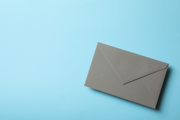 Gray envelope on blue background, space for text