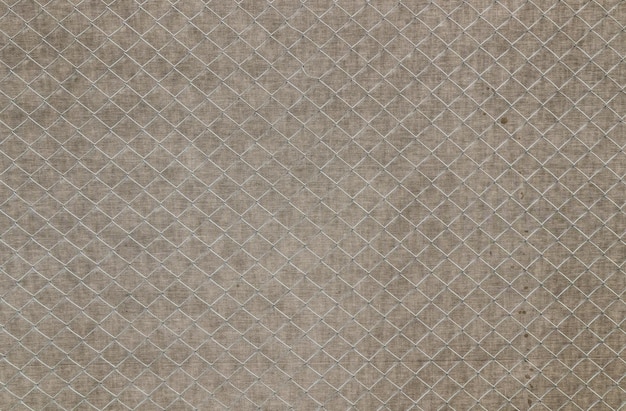 gray fabric background with a metal mesh in the foreground as a backdrop