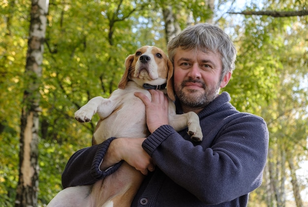 The gray-haired man of European appearance with the Beagle on his hands