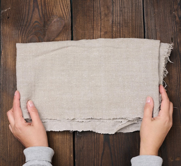 Gray linen kitchen towel on a brown table top view