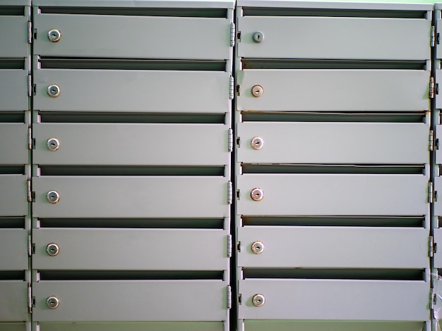 Gray metal mailboxes hanging on the wall Design element