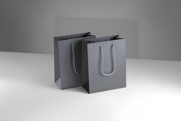 Photo gray paper glossy shopping bag mockup with gray handles