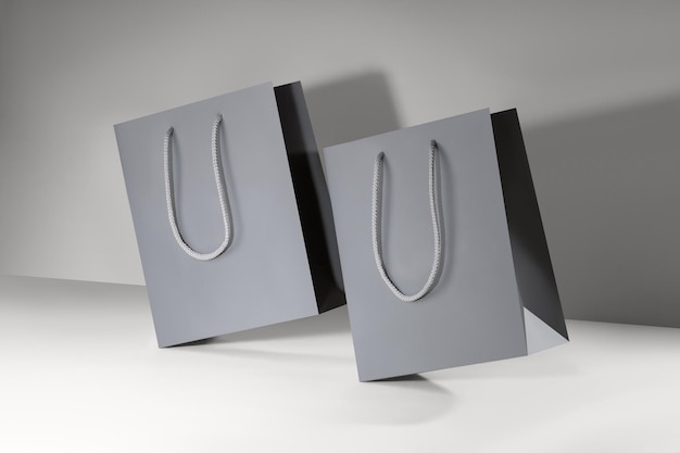 Gray paper glossy shopping bag mockup with gray handles