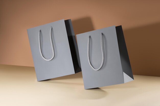 Photo gray paper glossy shopping bag mockup with gray handles