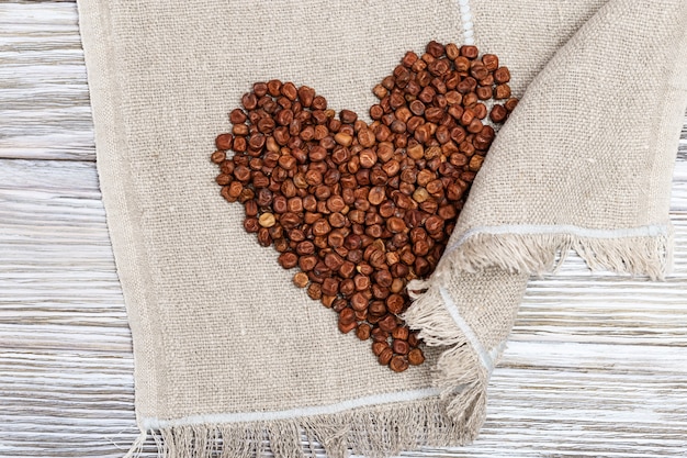 Gray peas scattered in form heart Gluten-free food Traditional Latvian product