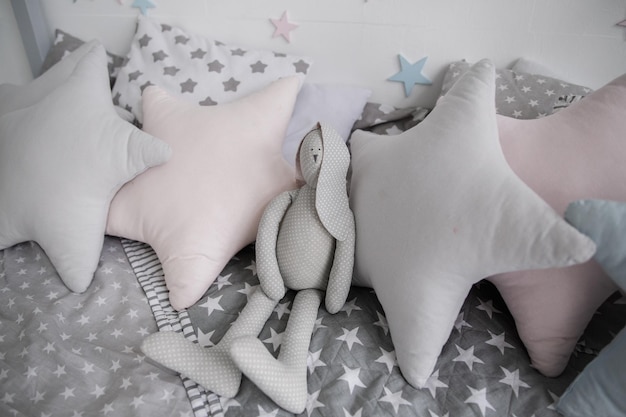 Gray pillows in the nursery on the bed