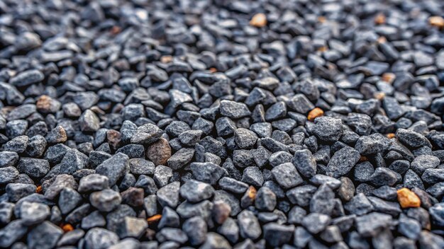 Gray small rocks ground texture black small road stone background gravel pebbles stone seamless texture dark background of crushed granite gravel close up clumping clay