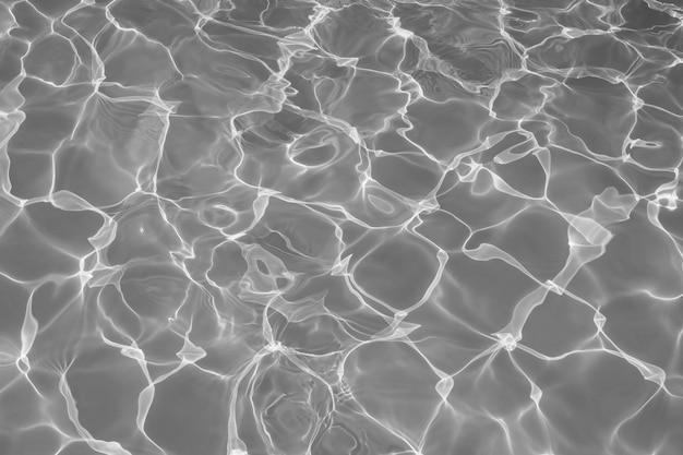 Gray water surface with bright sun light reflections Black and white water in swimming pool background