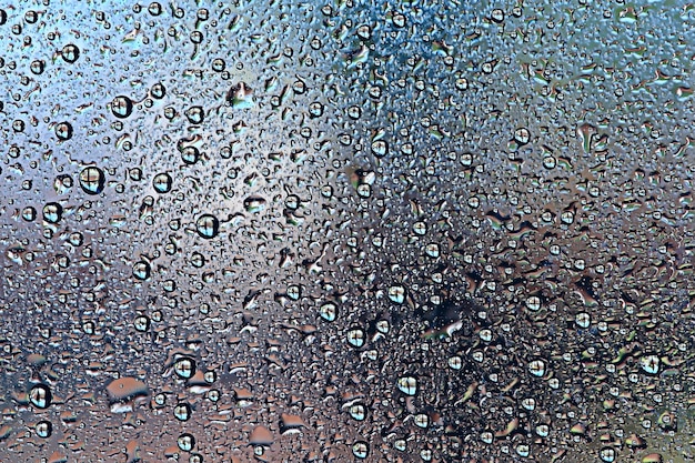 gray wet background / raindrops to overlay on the window, weather, background drops of water rain on the glass transparent