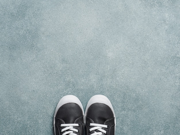 Gray and yellow sneakers on gray background