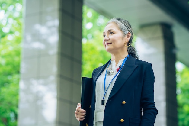 Grayhaired business woman standing outdoors