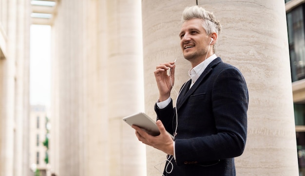 A grayhaired businessman goes to work in the office An entrepreneur surf the Internet