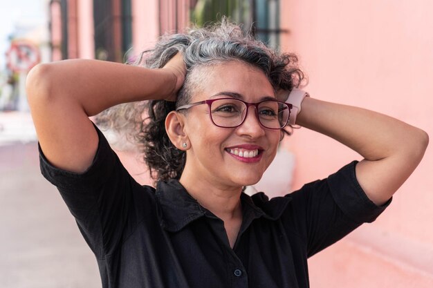 Grayhaired woman laughing outside