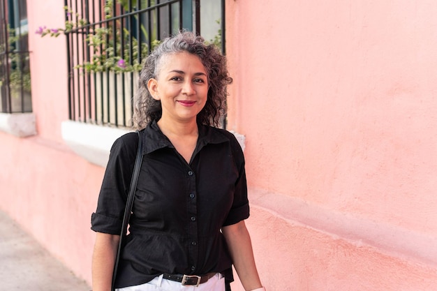 Grayhaired woman looking at the camera on the street