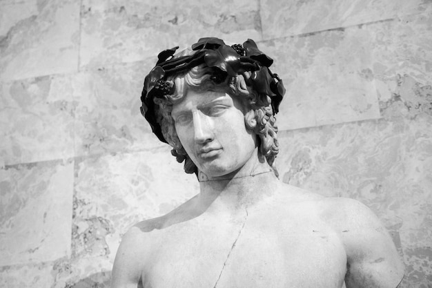 Grayscale shot of a marble statue of a male