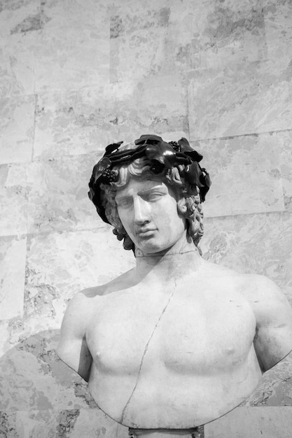 Grayscale shot of a marble statue of a male