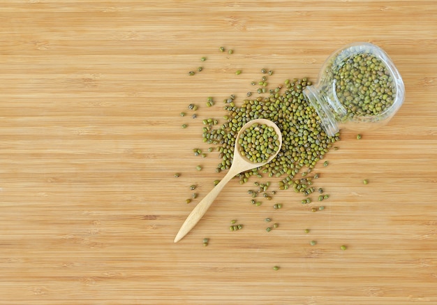 grean beans or Mung beans in bottle and wooden spoon 