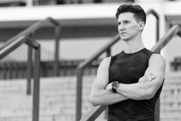 Great achievements on his mind concentrated handsome sportsman on stairs