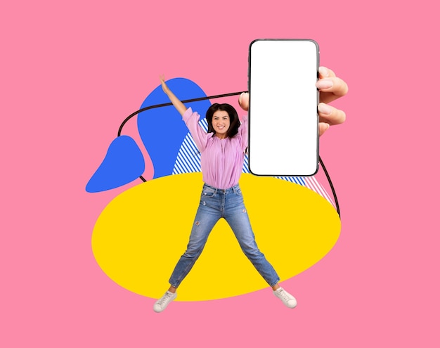 Great app joyful arab woman with blank smartphone jumping over colorful background