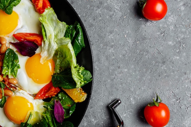 Great breakfast with fried eggs, toast, lettuce and tomato. Photographed in the vicinity.