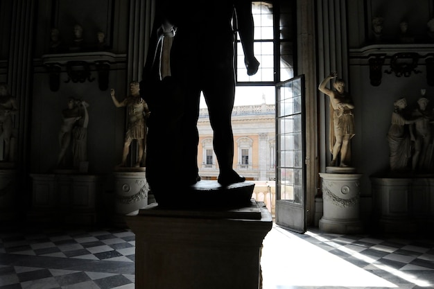 The great central hall in Capitoline Museum in Rome The window overlooks the Campidoglio The colossal basanite statue depicts the Baby Hercules is in the middle of the room Rome Italy