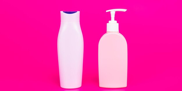 Great choice for dispensing products Pump and flip cap bottles Toiletry bottles pink background Cosmetic packing Refillable plastic containers For liquid products copy space