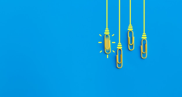 Great ideas concept with paperclip,thinking,creativity,light bulb on blue background,new ideas concept.