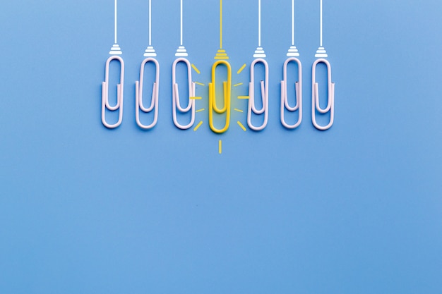 Great ideas concept with paperclip,thinking,creativity,light bulb on blue background.