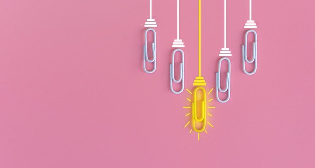 Great ideas concept with paperclip,thinking,creativity,light bulb on blue,new ideas concept.