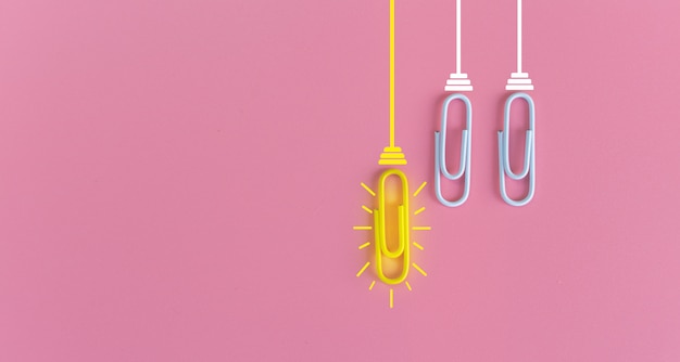 Great ideas concept with paperclip,thinking,creativity,light bulb on blue,new ideas concept.