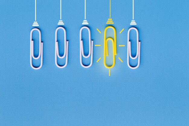 Great ideas  with paperclip,thinking,creativity,light bulb on blue background,new ideas 