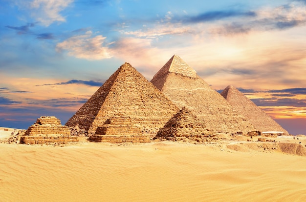 The Great Pyramids of Giza under a colorful desert sky Egypt