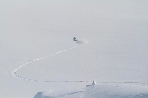 Great snowboarding line on white field freeride winter activity