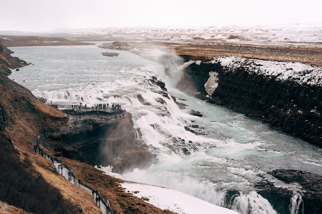 The great waterfall gullfoss in southern iceland on the golden ring tourists on the observation deck