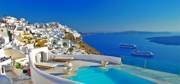 Greece travel. wonderful Santorini island holidays. Luxury resort with swimming pool and volcano view.