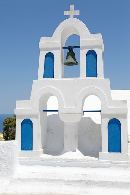 Greek church bell tower with blue sky in the background Oia Santorini Greece