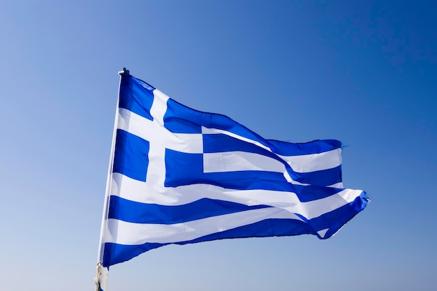 Greek flag waving under blue sky