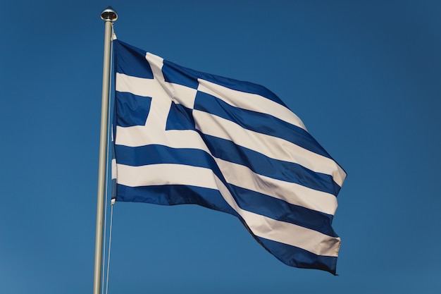 Greek flag with blue and white colours against sky background