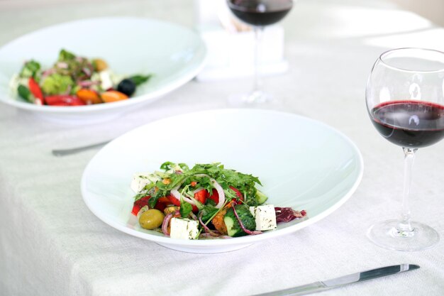 Greek salad on white plate close up