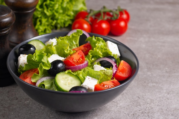 Greek salad with delicious rucola, spinach, arugula, feta cheese, cucumber, red onion and cherry