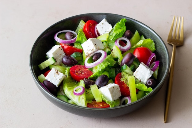 Greek salad with feta cheese tomatoes cucumbers peppers and Kalamata olives Healthy eating Vegetarian food