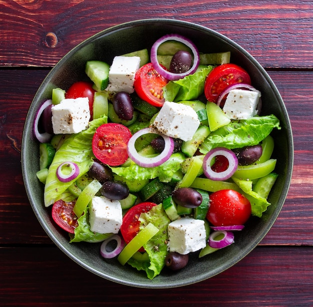 Greek salad with feta cheese tomatoes cucumbers peppers and Kalamata olives Healthy eating Vegetarian food