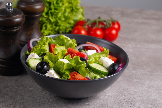 Greek salad with fresh tomatoes cucumber olives feta cheese and red onion Healthy and diet food concept