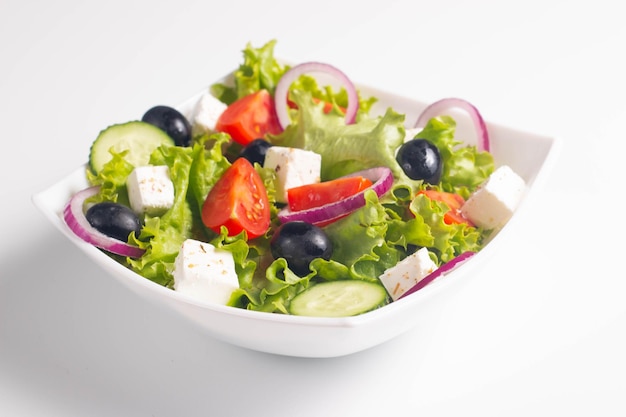 Greek salad with fresh tomatoes cucumber olives feta cheese and red onion Healthy and diet food concept