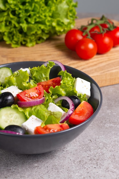 Greek salad with fresh tomatoes, cucumber, olives, feta cheese and red onion. Healthy and diet food